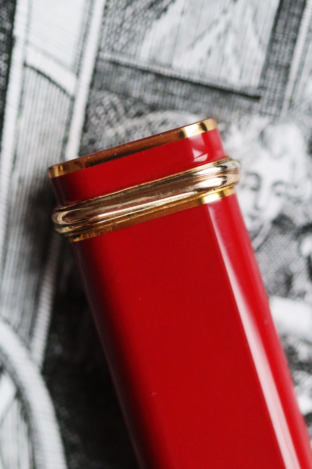 Cartier Trinity lighter, red lacquered with three gold accents